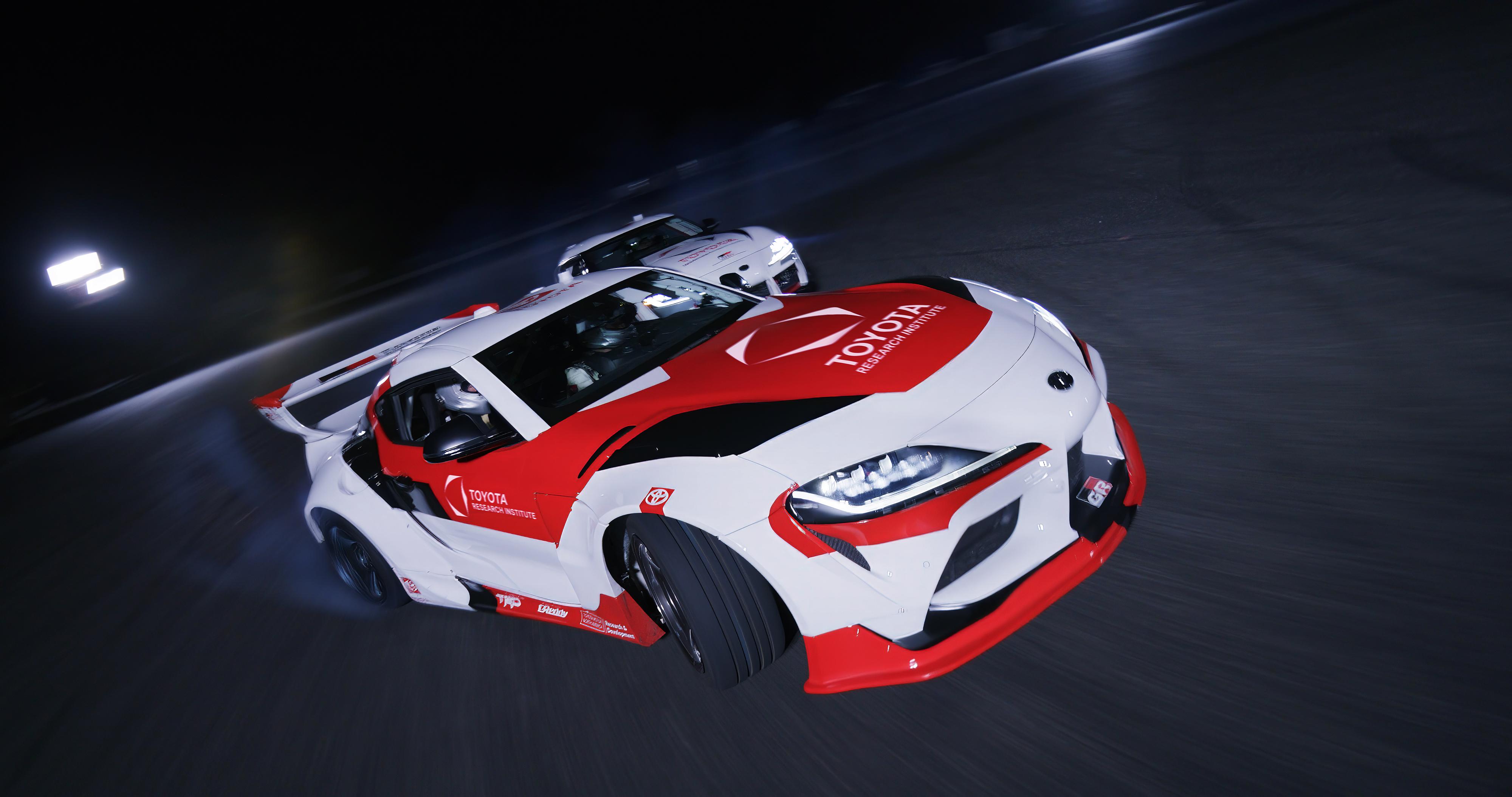 Action shot of Toyota Supras tandem drifting autonomously